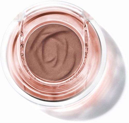 A round blush compact with light pink case and soft brown powder inside.