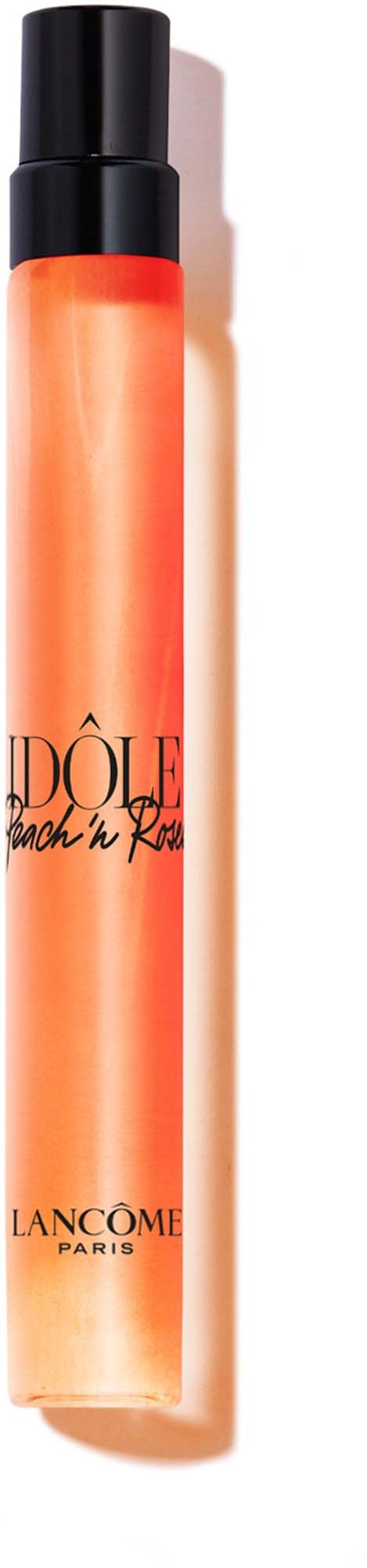 A tall, orange bottle with a black cap, labeled with black text and a logo, containing a beauty product.
