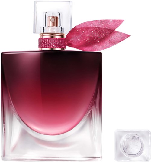 Eine pinke Parfümflasche mit klarem Deckel, pinkem Glitzerriemen und einer pinken Blattdekoration.