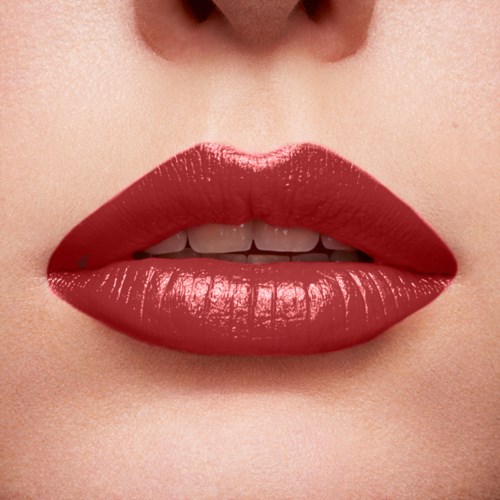Close-up of lips with bright red lipstick and slightly parted teeth.