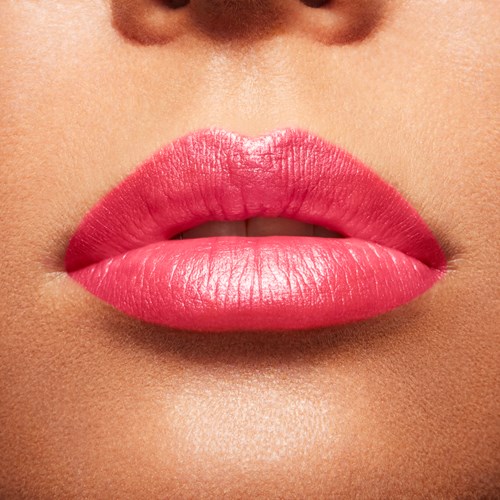 Close-up of full lips with bright pink lipstick and smooth skin.