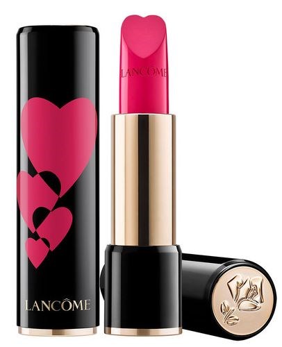 A lipstick with pink color inside, gold case, and black outer tube with pink hearts and 'Lancôme' logo.