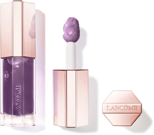 A purple lip gloss with a shiny pink cap, a purple-topped applicator, and a pink hexagonal container with 'Lancôme'.