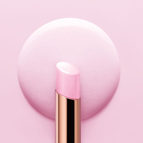 Ett rosa läppstift står på en vit cirkulär bakgrund, visar en glänsande guldrör och mjuk rosa färg.