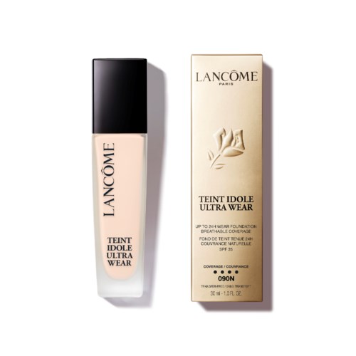 Butelka podkładu Lancôme i jej pudełko z logo kwiatu i szczegółami produktu w czerni i złocie.