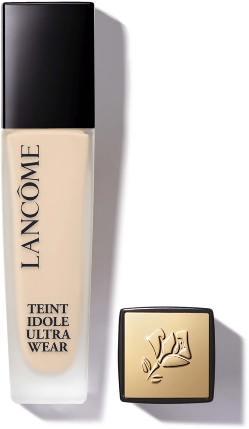 En flaska foundation från Lancôme med svart lock och ett litet beige kompakt med en roslogga.