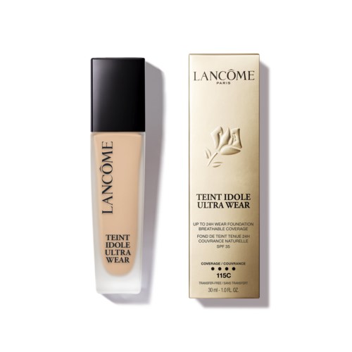 Butelka podkładu Lancôme obok opakowania, oba są beżowe z czarnymi i złotymi elementami.