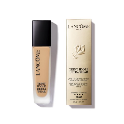 En foundationflaska och box för Lancôme Teint Idole Ultra Wear, båda i krämfärgat med svarta och gyllene detaljer.