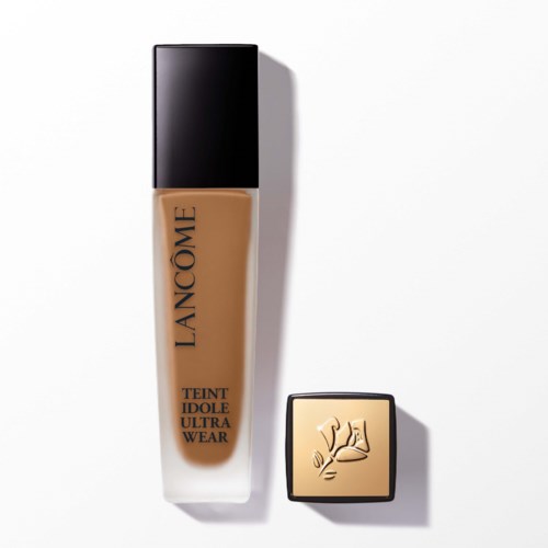 En flaska foundation från Lancôme med svart lock och en liten beige kompakta med en hand-uppsymbol.