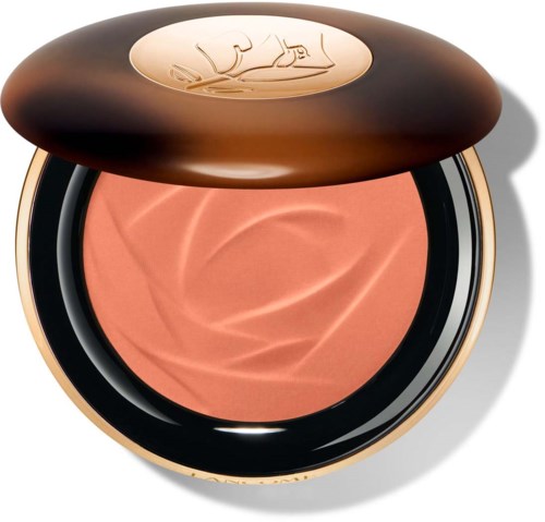 een compacte, ronde make-up blush met een bronze- en zwart bewaar, merklogo op de deksel, perzikkleurig product binnen.