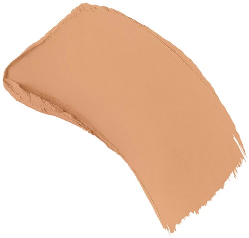 Ett beige schampuddsprov med kurvig form och ojämna kanter.