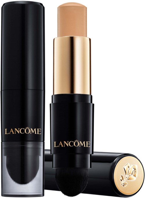 Lancôme foundation stick med sort og guld emballage, delvist åben viser produktet og en børste.