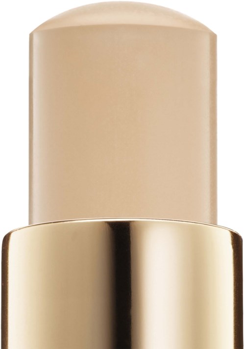 Et beige stykke eller fast produkt med en skinnende guldlåg.