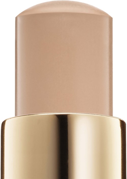 En beige foundations stick med en blank gullhætte.