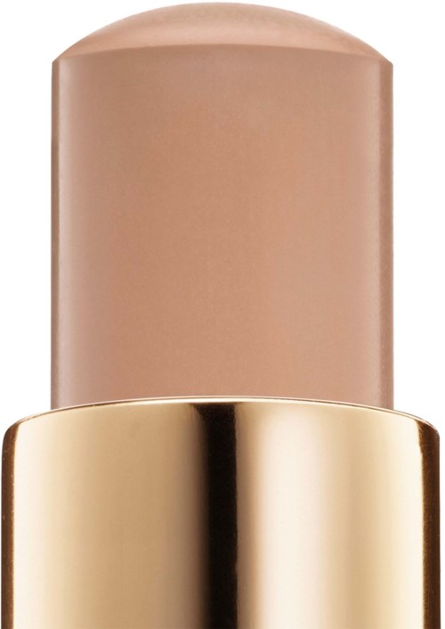 En beige stift af foundation eller concealere med en guldbase.