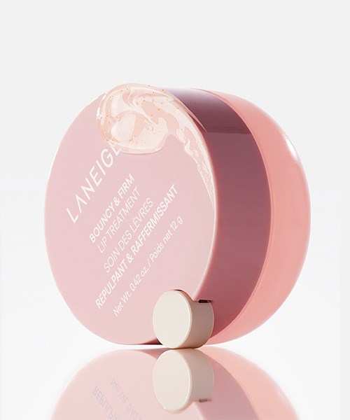 Rund rosa beholder med hvit rulle, merket 'LANEIGE Beauty Firm' på lokket.