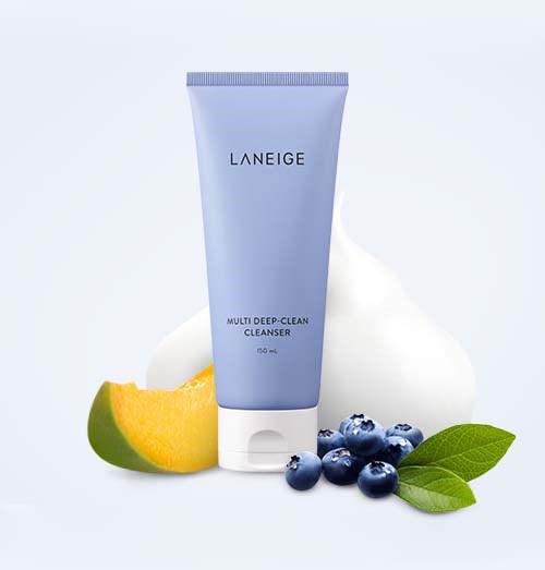 A blue tube of Laneige Multi Deep-Clean Cleanser with mango, blueberries, and green leaves in the background.