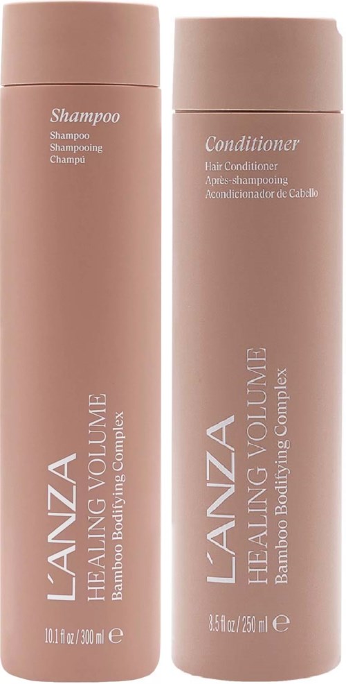 Dwie różowe butelki oznaczone szampon i odżywka stoją obok siebie. Z serii L'ANZA Healing Volume, do włosów.