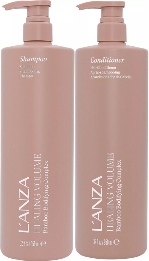 Twee roze flessen met pompjes, gemerkt shampoo en conditioner voor haarverzorging.