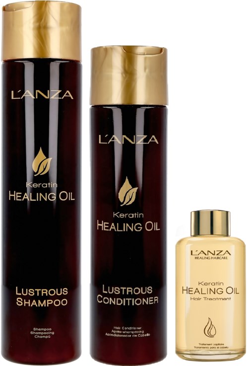 Tre L'ANZA hårprodukter: sjampo, balsam og behandlingolje, alle med gullhatter og mørke flasker.