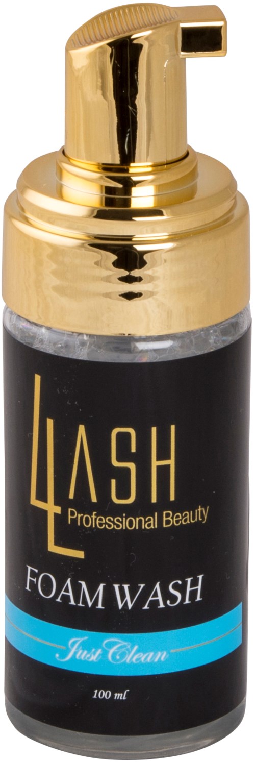 En skumtvättflaska med guldpump, svart etikett och blå accenter, märkt 'LASH PROFESSIONAL BEAUTY' och 'FOAM WASH.'