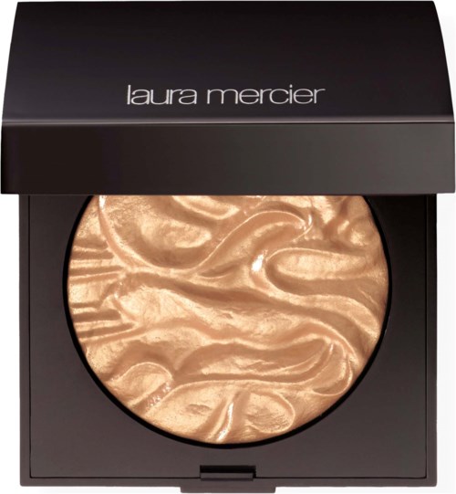 A compact with a shiny, golden, swirled makeup highlighter from Laura Mercier.