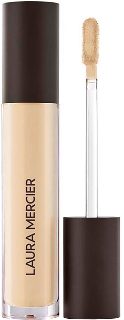 Flaskan med flytande foundation med svart lock och applikator. Laura Mercier är tydlig.