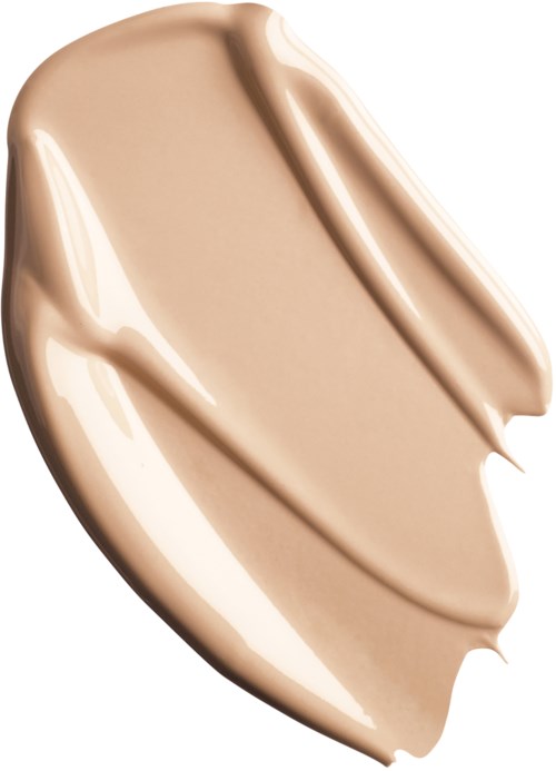 En beigefärgad krämig substans med slät textur och böjda streck, liknande foundation eller concealer.