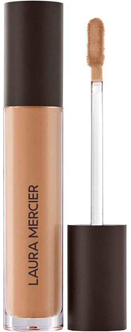 A beige liquid concealer in a clear tube with black cap, and an applicator wand. Laura Mercier logo on the tube.
