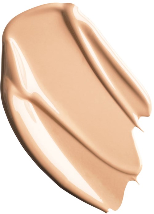 En beige vätska som stryks i tjocka drag, slät och glänsande, kanske foundation eller makeup.