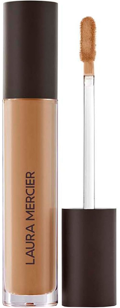 En tub med flytande foundation med svart lock och beige nyans, märkt Laura Mercier, med applikator.