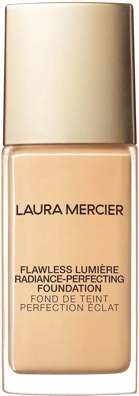 A bottle of Laura Mercier foundation with a gold cap and beige liquid inside.