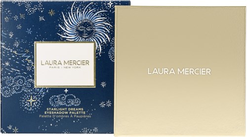 A blue box with stars and a sun, and a gold box, both labeled Laura Mercier, for eyeshadow makeup.