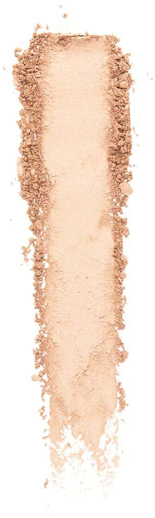 Et beige pulver spredd i en lang, smal form på en hvit bakgrunn.
