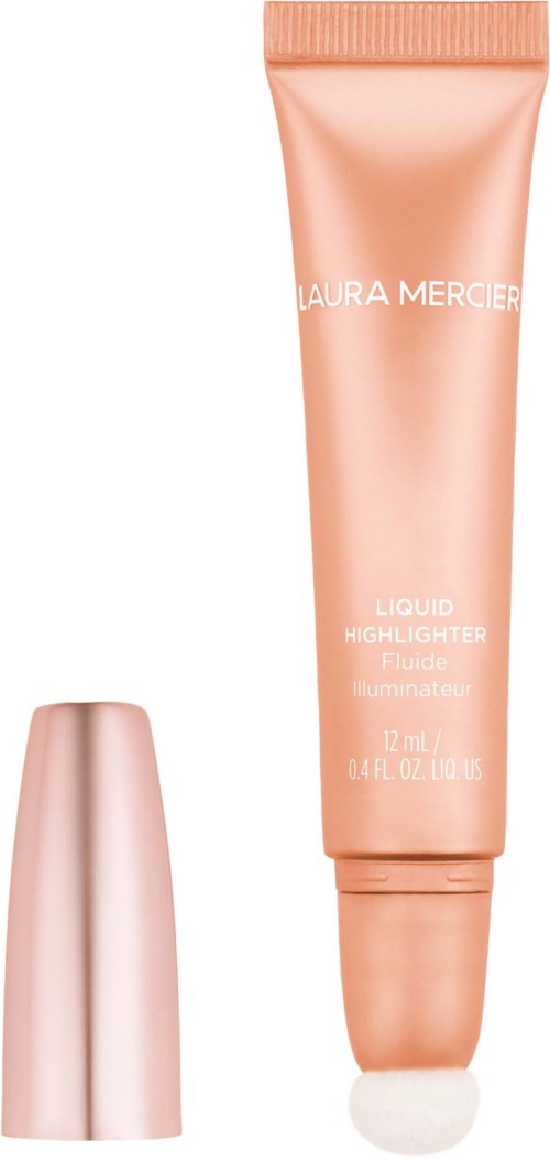 En tube av Laura Mercier flytande highlighter med ett roséguld lock och en glansig, persikofärgad kropp.