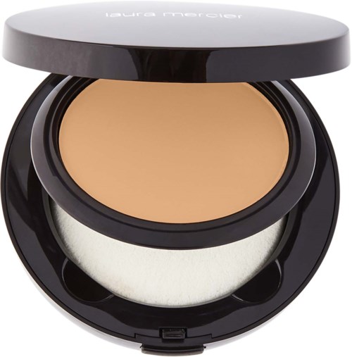A compact makeup case with pressed powder and a mirror inside. The case is black and round.