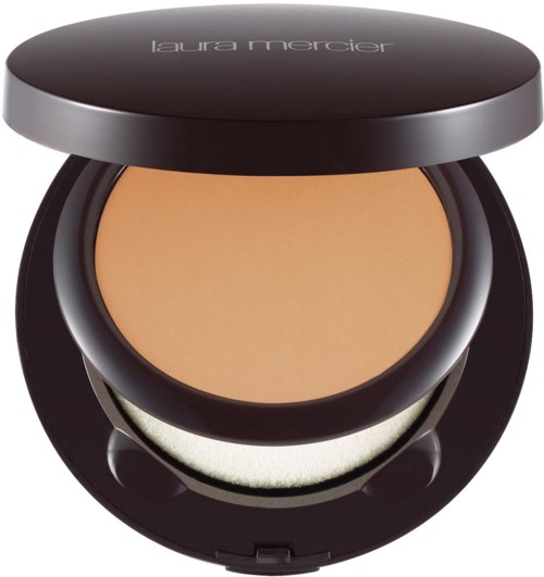 A compact makeup product with beige powder and a black case, labeled 'laura mercier'.