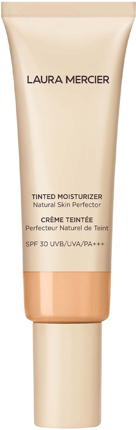 En beige tub med Laura Mercier färgad fuktkräm med SPF 30, märkt som naturlig hudförbättring.