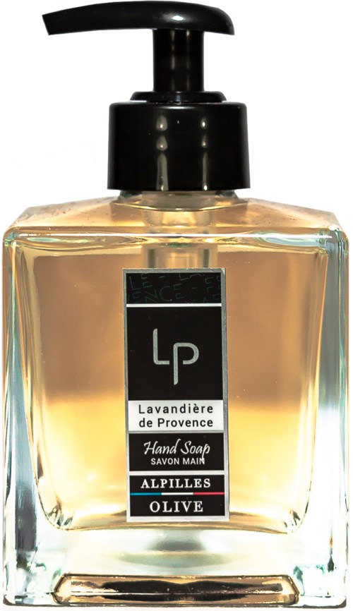 En tydlig tvållåda med svart pump, etiketten visar lavendel, Provence, oliv och handtvål. Guldfärgad vätska inuti.