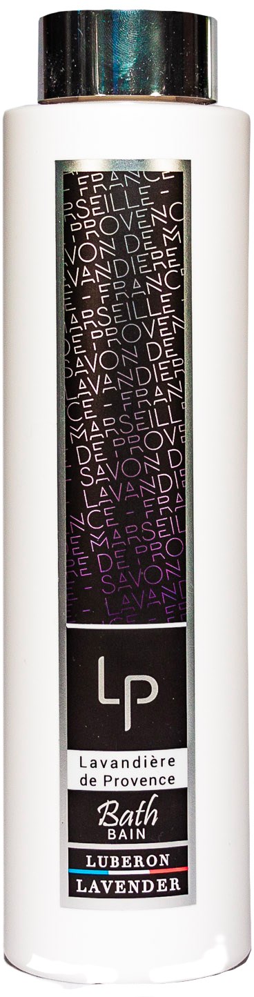 En vit flaska med svart lock, märkt 'Lavandière de Provence' lavendelbadtvål från Luberon, med lila inslag.