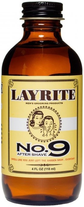 En liten brun glasflaska med svart lock, etiketten säger 'Layrite No. 9 After Shave'.