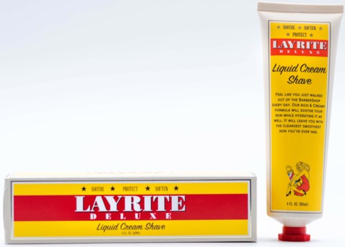 Tölkki ja rasia Layrite Deluxe Liquid Cream Shave -tuotteelle, keltainen ja punainen pakkaus, kuvitus tubissa.