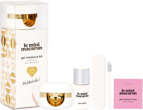 Nagelvårdskit innehåller nagellack, remover och gelwrap, alla i vitt och guldpaket, med varumärket 'le mini macaron.'