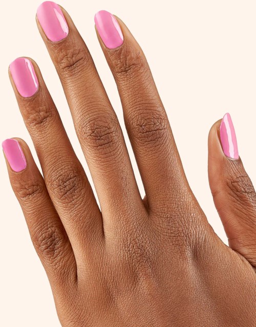 A hand with pink and white nail polish on the nails.