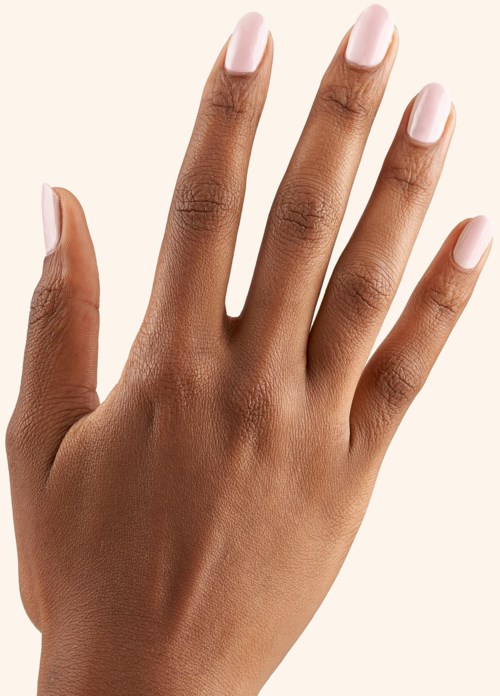 A hand with neatly painted light pink nails, fingers slightly spread apart, skin tone medium. Simple, clean look.