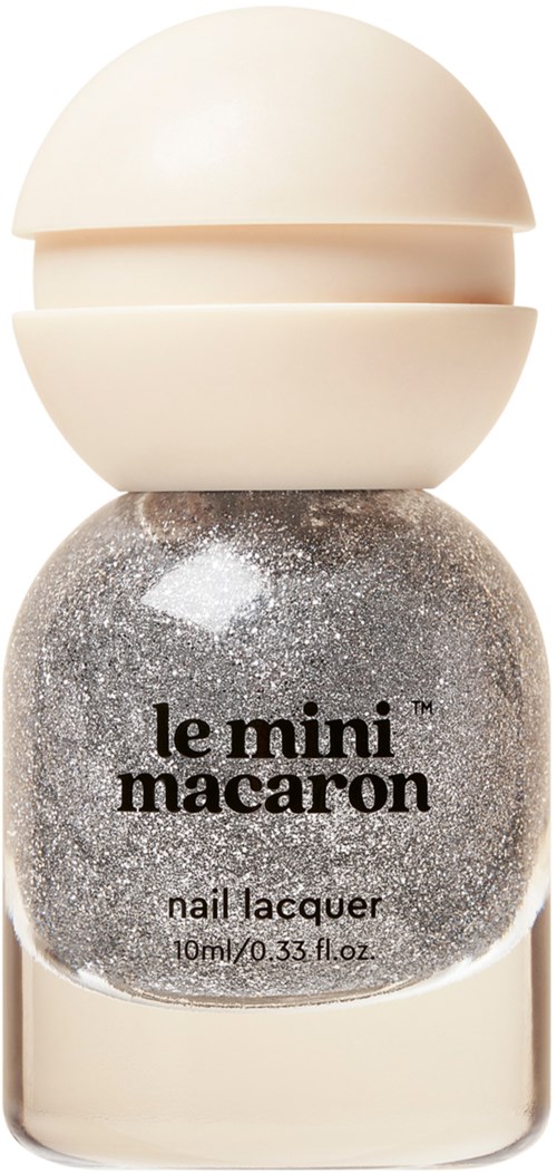 A nail polish bottle with black and silver glitter and a cream-colored cap.