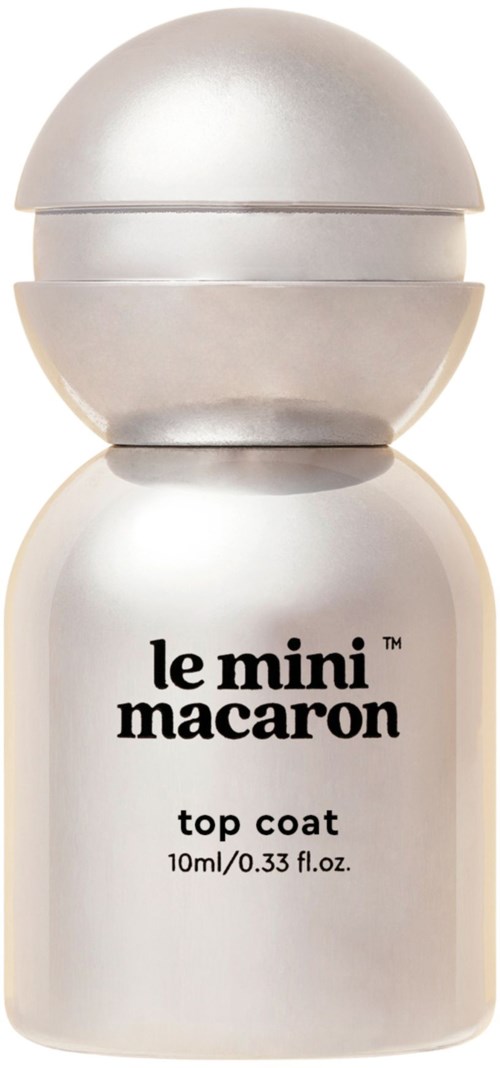 A white bottle with a rounded top, labeled "le mini macaron top coat" for nail polish.