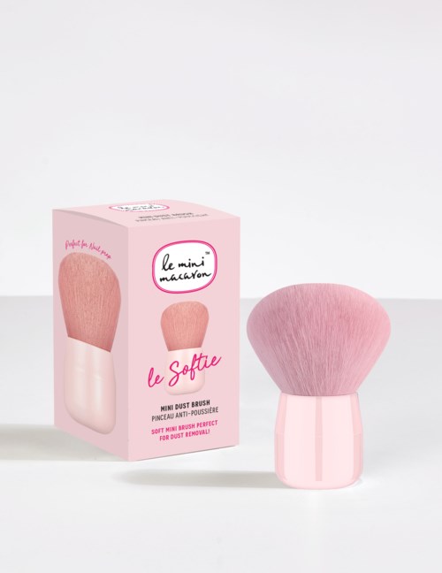 A pink makeup brush with a soft, rounded top and a matching pink handle, shown next to its box.