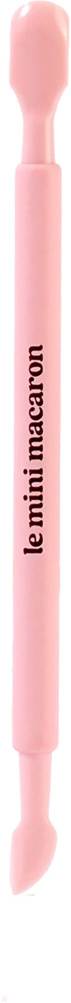A pink makeup tool with the words "le mini macaron" on it, resembling a small double-ended stick.