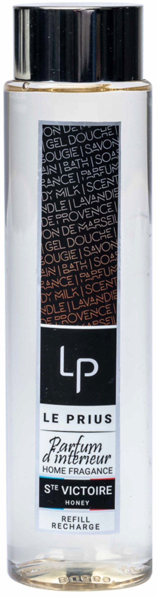 A tall clear bottle with a black cap, labeled 'Le Priori', containing honey-scented home fragrance. Refill and recharge only.